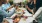 a group of people having a meal around an outdoor table