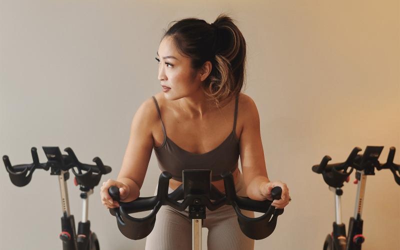 a woman riding a stationary bike