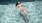 woman floats on her back in swimming pool